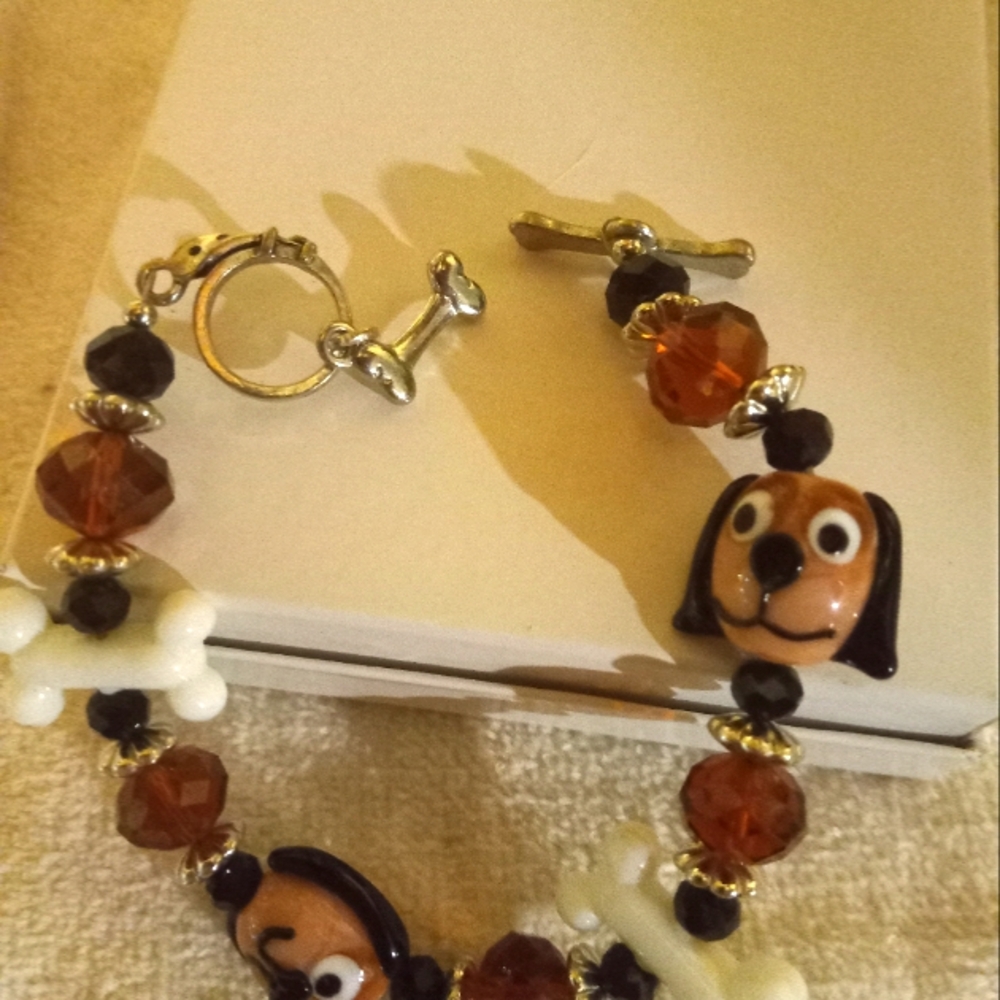 Handmade  glass dog braclet with glass dog bones and dog 🐶 faces and beads.